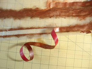 Carefully peel the tape from the wax paper. Trim off any excess paint with scissors or  craft knife.