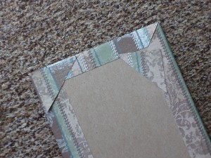 If you cut your angles incorrectly, you might wind up with a gap on the miter. Resolve this by gluing the pieces of card stock cut from the corners to cover the gap.