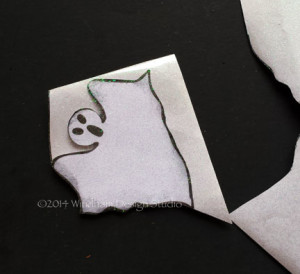 Apply Kool Tak™ Sparkly Adhesive to the ghost cutout from the pdf file.