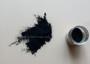 Remove the release paper and cover with black embossing powder. Tap off the excess and return it to the container.