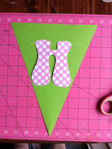 Find the lower edge paper center and trim from each upper corner to the lower center to create the pennants.