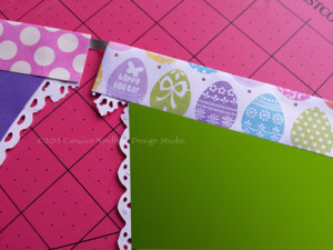 Remove the release paper from the pennant topper and fold the remaining edge of the topper down and adhere.